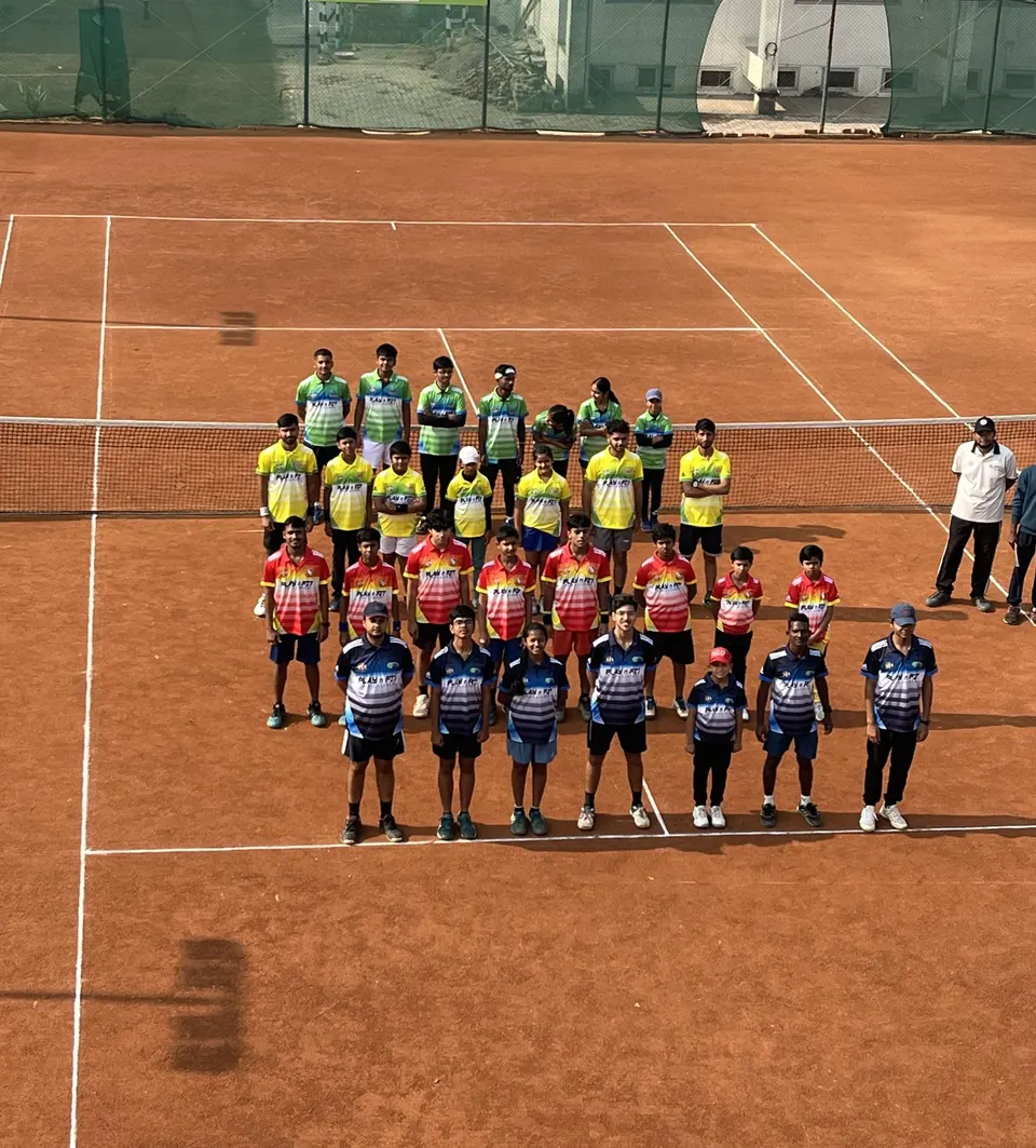 PLAY n FIT squad standing in formation on a clay court